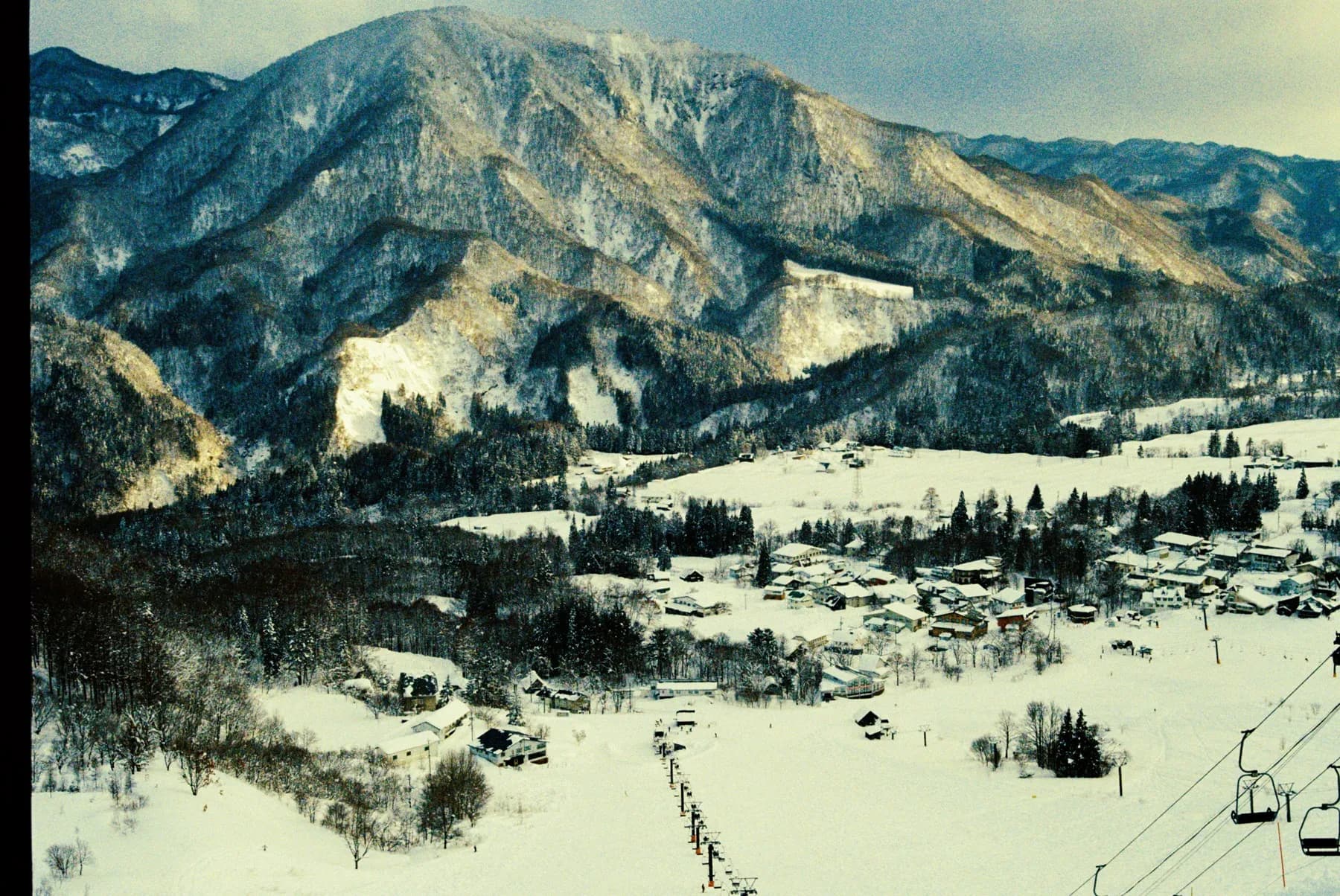 Red-roofed ski resort village tucked under the Japanese Alps